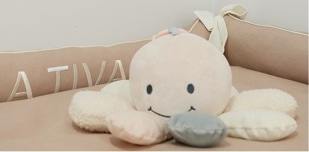 La Tiva soft toy on a nursery bed